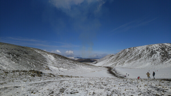 Trail through the hills, with the fumes-spewing volcano visible between them.