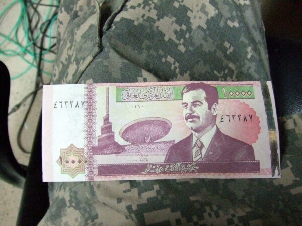 An image of some now defunct Iraqi currency featuring Saddam Hussein.