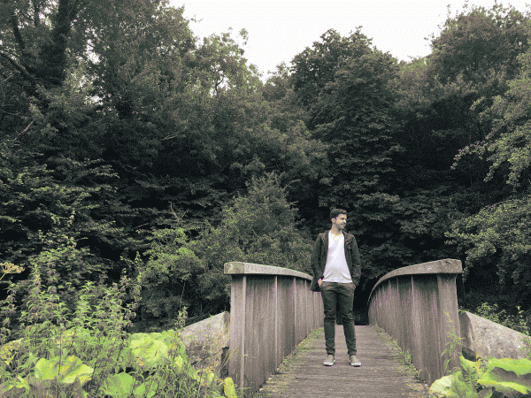 jonathan gray on a bridge surrounded by bushes and trees on the way from the water of leith to the scottish national gallery of modern art in edinburgh