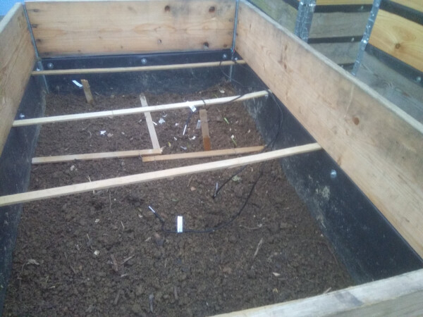 The raised bed with several cables leading to different temperature sensors