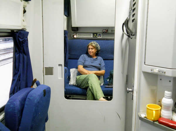 Woman riding in the best seat on the train as a result of a scheduling mishap.