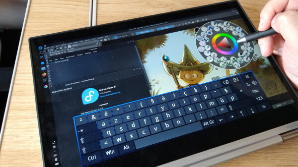 A photo of the Lenovo 370 Yoga device, running Fedora with a digital quick painting of Carrot in Krita done in the train. The keyboard on screen is 'onboard' and the system settings shows the Fedora logo. A terminal windows has 'Hello World!' written on it.