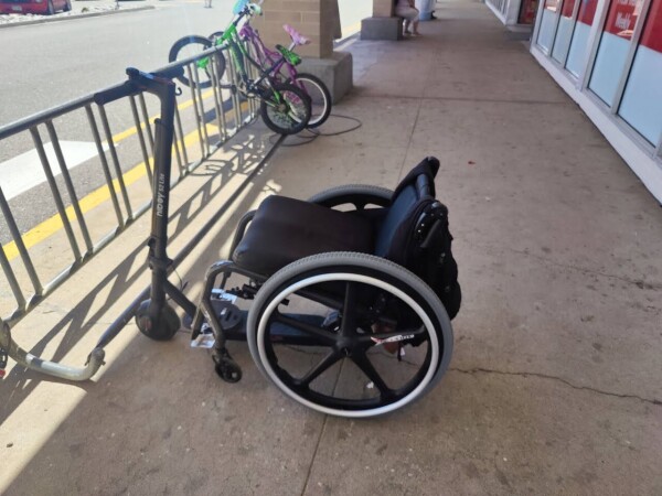 My wheelchair  attached to my scooter. Both can be seen both fully from the side.