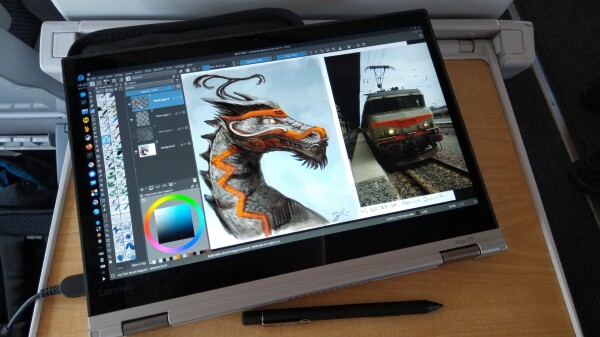 A photo of my lenovo 370 laptop running fedora kde. Krita has a painting on the canvas : a dragon colored and stylised in the same way than my ref photo (a ccbysa photo by patrick janicek on wikimedia commons). The shot is taken... In the train.