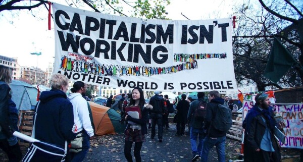 Banner at a protest rally says: "Capitalism isn't working. Another world is possible."