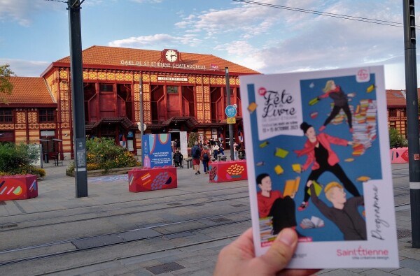 The brochure of the festival in front of the train station of Saint-Etienne.