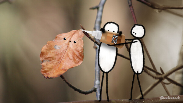 A photograph of a some thin intertwined branches of a tree and a single autumn leaf left on a branch against a soft focus brown background. Two simple drawn figures stand on a branch near it, holding up and squeezing a tube of superglue to glue the connection between leaf and branch.  The leaf has a little happy face drawn on.