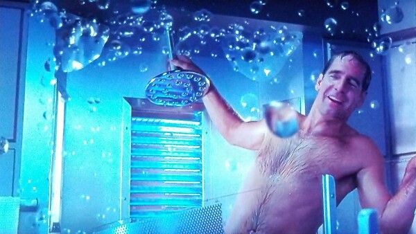 Enterprise scene. We're in Captain Archer's personal bathroom looking at the shower. Water globules are floating everywhere. Archer, buck naked, looks to be floating in air and holding onto the shower head for balance. He's smiling, wet, and looks kind of drunk. No caption. 