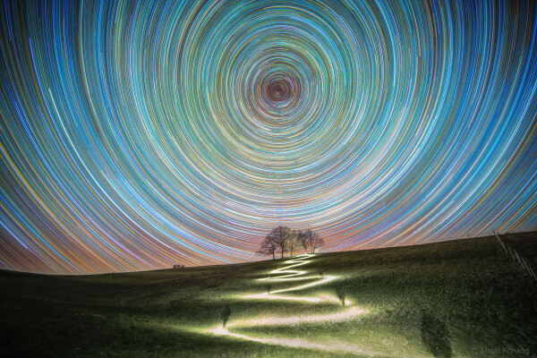 2020 April 7

A Path North
Image Credit & Copyright: Mario Konang

Explanation: 
What happens if you keep going north? The direction north on the Earth, the place on your horizon below the northern spin pole of the Earth -- around which other stars appear to slowly swirl, will remain the same. This spin-pole-of-the-north will never move from its fixed location on the sky -- night or day -- and its height will always match your latitude. The further north you go, the higher the north spin pole will appear. Eventually, if you can reach the Earth's North Pole, the stars will circle a point directly over your head. Pictured, a four-hour long stack of images shows stars trailing in circles around this north celestial pole. The bright star near the north celestial pole is Polaris, known as the North Star. The bright path was created by the astrophotographer's headlamp as he zigzagged up a hill just over a week ago in Lower Saxony, Germany. The astrophotographer can be seen, at times, in shadow. Actually, the Earth has two spin poles -- and much the same would happen if you started below the Earth's equator and went south. 

Authors & editors: Robert Nemiroff (MTU) & Jerry Bonnell (UMCP)
NASA Official: Phillip Newman Specific rights apply.
NASA Web Privacy Policy and Important Notices
A service of: ASD at NASA / GSFC
& Michigan Tech. U.