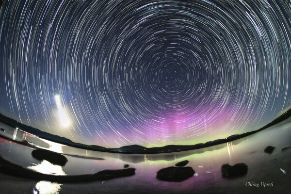 2024 May 18

North Celestial Aurora
 * Image Credit & Copyright: Chirag Upreti

Explanation: 
Graceful star trail arcs reflect planet Earth's daily rotation in this colorful night skyscape. To create the timelapse composite, on May 12 consecutive exposures were recorded with a camera fixed to a tripod on the shores of the Ashokan Reservoir, in the Catskills region of New York, USA. North star Polaris is near the center of the star trail arcs. The broad trail of a waxing crescent Moon is on the left, casting a strong reflection across the reservoir waters. With intense solar activity driving recent geomagnetic storms, the colorful aurora borealis or northern lights, rare to the region, shine under Polaris and the north celestial pole. 

Authors & editors: Robert Nemiroff (MTU) & Jerry Bonnell (UMCP)
NASA Official: Amber Straughn Specific rights apply.
NASA Web Privacy, Accessibility Notices
A service of: ASD at NASA / GSFC,
NASA Science Activation
& Michigan Tech. U.