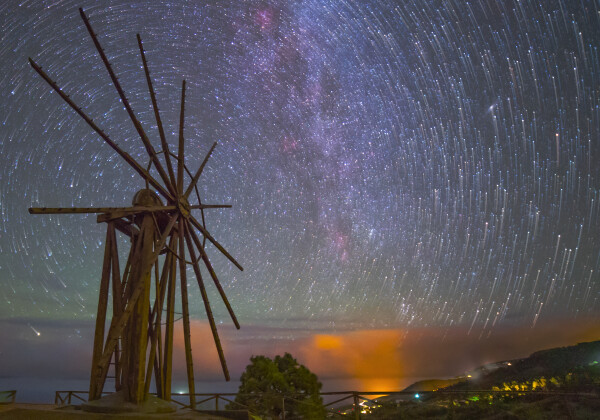 2020 April 17

The Windmill and the Star Trails
 * Image Credit & Copyright: Antonio Gonzalez

Explanation: 
Stars can't turn these old wooden arms, but it does look like they might in this scene from a rotating planet. The well-composed night skyscape was recorded from Garafia, a municipality on the island of La Palma, Canary Islands, planet Earth. The center of the once working windmill, retired since 1953, is lined-up with the north celestial pole, the planet's rotation axis projected on to the northern sky. From a camera fixed to a tripod, the star trails are a reflection of the planet's rotation traced in a digital composite of 39 sequential exposures each 25 seconds long. Brought out by highlighting the final exposure in the sequence, the stars themselves appear at the ends of their short concentric arcs. A faint band of winter's Milky Way and even a diffuse glow from our neighboring Andromeda Galaxy also shine in the night. 

Authors & editors: Robert Nemiroff (MTU) & Jerry Bonnell (UMCP)
NASA Official: Phillip Newman Specific rights apply.
NASA Web Privacy Policy and Important Notices
A service of: ASD at NASA / GSFC
& Michigan Tech. U.