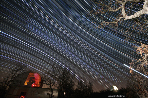 2009 March 14

Haute-Provence Star Trails
 * Credit & Copyright: Alexandre Santerne / OHP-CNRS

Explanation: 
Fix your camera to a tripod and you can record the graceful trails traced by the stars as planet Earth rotates on its axis. For example, this dramatic 5 hour long exposure was made on February 24 from Haute-Provence Observatory (OHP) in southeastern France. Actually a composite of 300 consecutive 1-minute exposures, the image nicely shows stars near the celestial equator tracing nearly straight lines in projection, while stars north and south of the equator, respectively, appear to circle the north and south celestial poles. Domes at the bottom left and right house the OHP telescopes. Brilliant planet Venus makes the short bright trail at the lower right, while trails of stars in the constellation Orion end near the lower right observatory dome. Sirius, alpha star of Canis Major, traces the bright arc over the dome at the left. Astronomer Alexandre Santerne also briefly illuminated a foreground oak tree during the exposure sequence. 

Authors & editors: Robert Nemiroff (MTU) & Jerry Bonnell (UMCP)
NASA Official: Phillip Newman Specific rights apply.
NASA Web Privacy Policy and Important Notices
A service of: ASD at NASA / GSFC
& Michigan Tech. U.