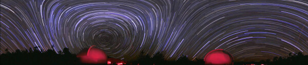 2010 July 11

Warped Sky: Star Trails Panorama
 * Credit & Copyright: Peter Ward

Explanation: 
What's happened to the sky? A time warp, of sorts, and a digital space warp too. The time warp occurs because this image captured in a single frame a four hour exposure of the night sky. As a result, prominent star trails are visible. The space warp occurs because the picture is actually a full 360 degree panorama, horizontally compressed to fit your browser. As the Earth rotated, stars appeared to circle both the South Celestial Pole, on the left, and the North Celestial Pole, just below the horizon on the right. The image captured the sky over Mudgee, New South Wales, Australia, including the domes of two large telescopes illuminated by red lighting. A horizontally unwarped image is visible by clicking on the image. 

Authors & editors: Robert Nemiroff (MTU) & Jerry Bonnell (UMCP)
NASA Official: Phillip Newman Specific rights apply.
NASA Web Privacy Policy and Important Notices
A service of: ASD at NASA / GSFC
& Michigan Tech. U.