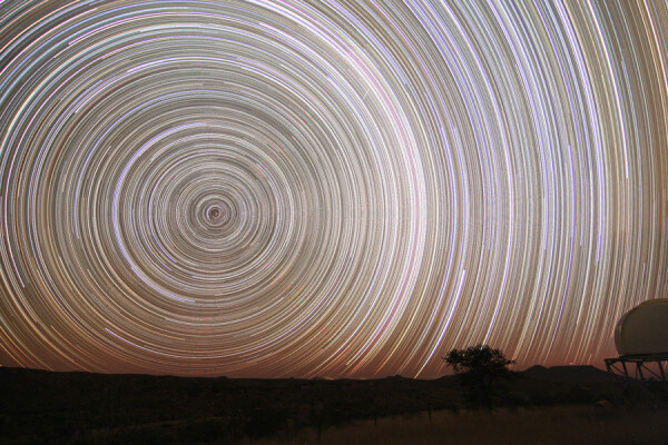 2006 September 15

11 Hour Star Trails
Credit & Copyright: Josch Hambsch

Explanation: 
Fix your camera to a tripod, lock the shutter open, and you can make an image of star trails - graceful concentric arcs traced by the stars as planet Earth rotates on its axis. Of course, the length of the star trails will depend on the exposure time. While exposures lasting just five minutes produce a significant arc, in about 12 hours a given star would trace out half a circle. But in any long exposure, the background glow from light-polluted skies can build up to wash out the trails. Still, astronomer Josch Hambsch produced this stunning composite of star trails around the South Celestial Pole with an effective "all night" exposure time of almost 11 hours. To do it, he combined 128 consecutive five minute long digital exposures recorded in very dark night skies above Namibia. In his final image, the background glow on the right is due in part to the faint, arcing Milky Way. 

Authors & editors: Robert Nemiroff (MTU) & Jerry Bonnell (UMCP)
NASA Official: Phillip Newman Specific rights apply.
NASA Web Privacy Policy and Important Notices
A service of: ASD at NASA / GSFC
& Michigan Tech. U.