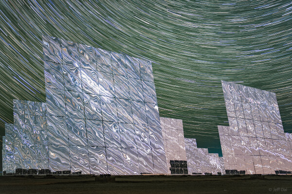 2023 September 22

Cosmos in Reflection
 * Image Credit & Copyright: Jeff Dai (TWAN)

Explanation: 
During the day, over 12,000 large mirrors reflect sunlight at the 100-megawatt, molten-salt, solar thermal power plant at the western edge of the Gobi desert near Dunhuang, Gansu Province, China. Individual mirror panels turn to track the sun like sunflowers. They conspire to act as a single super mirror reflecting the sunlight toward a fixed position, the power station's central tower. During the night the mirrors stand motionless though. They reflect the light of the countless distant stars, clusters and nebulae of the Milky Way and beyond. This sci-fi night skyscape was created with a camera fixed to a tripod near the edge of the giant mirror matrix on September 15. The camera's combined sequence of digital exposures captures concentric arcs of celestial star trails through the night with star trails in surreal mirrored reflection. 

Authors & editors: Robert Nemiroff (MTU) & Jerry Bonnell (UMCP)
NASA Official: Phillip Newman Specific rights apply.
NASA Web Privacy Policy and Important Notices
A service of: ASD at NASA / GSFC
& Michigan Tech. U.