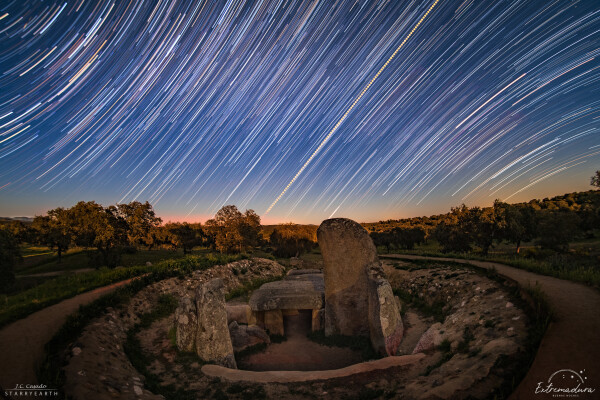 2019 March 21

Star Trails and the Equinox Sunrise
 * Image Credit & Copyright: Juan Carlos Casado (TWAN, Earth and Stars)
Acknowledgement: Andrea Rodriguez Anton

Explanation: 
Stars trail and the Sun rises in this night and day composite panorama made on March 19. The view looks toward the eastern horizon from La Nava de Santiago, Spain. To create it, a continuous series of digital frames was recorded for about two hours and combined to trace the concentric motion of the stars through the night sky. A reflection of the Earth's rotation, star trails curve around the north celestial pole toward upper left and the south celestial pole toward the lower right. Of course on that day the Sun was near the celestial equator, a diagonal straight line in the wide-angle projection. A dense dimming filter was used to capture the Sun's image every two minutes. Superimposed on the star trails it rose due east in the morning sky. In the scene, foreground landscape and a local prehistoric monument were illuminated by full moonlight, though. The monument's corridor faces nearly to the east and the equinox sunrise. 

Authors & editors: Robert Nemiroff (MTU) & Jerry Bonnell (UMCP)
NASA Official: Phillip Newman Specific rights apply.
NASA Web Privacy Policy and Important Notices
A service of: ASD at NASA / GSFC
& Michigan Tech. U.