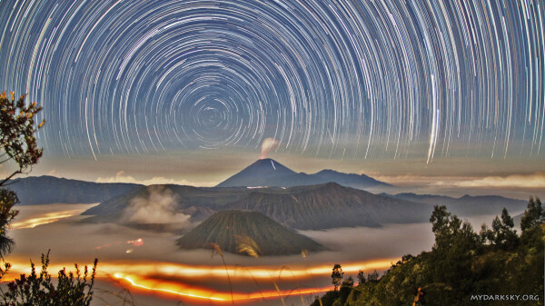 2014 August 18 

Star Trails Over Indonesia
 *Image Credit & Licence: HuiChieh (my dark sky)

Explanation: 
Both land and sky were restless. The unsettled land included erupting Mount Semeru in the distance, the caldera of steaming Mount Bromo on the left, flowing fog, and the lights of moving cars along roads that thread between hills and volcanoes in Bromo Tengger Semeru National Park in East Java, Indonesia. The stirring sky included stars circling the South Celestial Pole and a meteor streaking across the image right. The above 270-image composite was taken from King Kong Hill in mid-June over two hours, with a rising Moon lighting the landscape. 

Authors & editors: Robert Nemiroff (MTU) & Jerry Bonnell (UMCP)
NASA Official: Phillip Newman Specific rights apply.
NASA Web Privacy Policy and Important Notices
A service of: ASD at NASA / GSFC
& Michigan Tech. U.