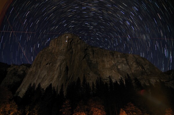2014 March 21

Star Trails over El Capitan
 * Image Credit & Copyright: Michael Bolte (UCSC)

Explanation: 
Towering 3,000 feet from base to summit, the famous granite face of El Capitan in Earth's Yosemite National Park just hides the planet's north celestial pole in this skyscape. Of course, the north celestial pole is at the center of all the star trails. Their short arcs reflecting the planet's daily rotation on its axis are traced in a digital stack of 36 sequential exposures. Linear trails of passing airplane navigation lights and a flare from car lights along the road below are also captured in the sequential stack. But the punctuated trail of light seen against the sheer El Capitan itself follows a climbing team on the night of November 8, 2013. The team is ascending toward the summit along The Nose, a historic rock climbing route. 

Authors & editors: Robert Nemiroff (MTU) & Jerry Bonnell (UMCP)
NASA Official: Phillip Newman Specific rights apply.
NASA Web Privacy Policy and Important Notices
A service of: ASD at NASA / GSFC
& Michigan Tech. U.