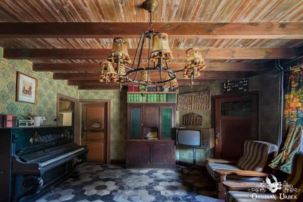 loving room with piano and chandlier