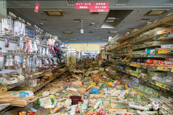 Aisle of abandoned supermarket, goods all over the floor