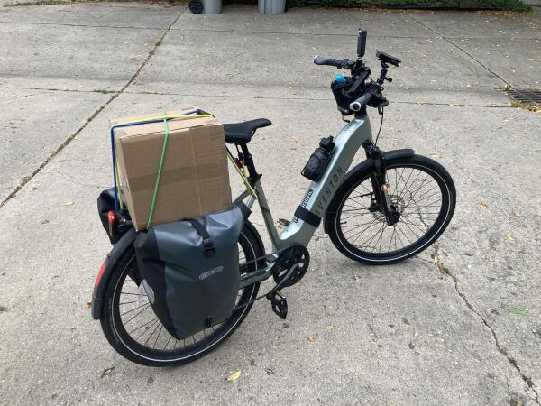 Bike with giant box on the back rack.