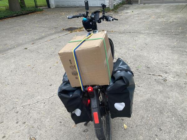 Bike with giant box on the back rack.